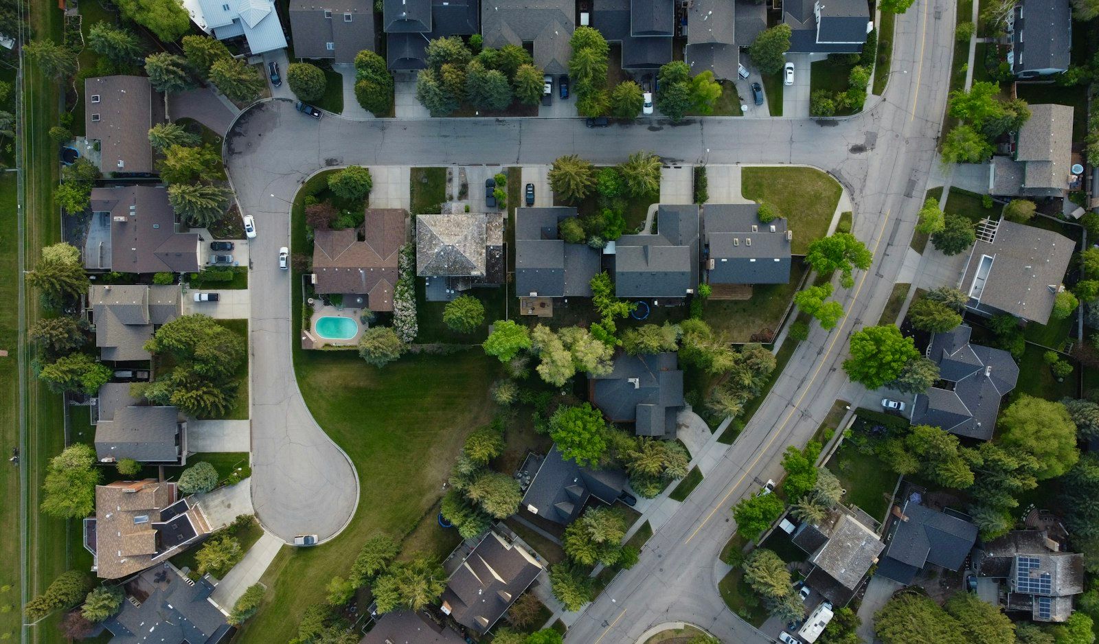 Aerial view of a suburban street and surrounding house roofs